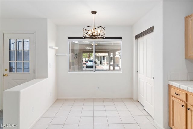 2219 Rugged Mesa Dr, Laughlin, NV 89029 - unfurnished dining area with a chandelier and baseboards