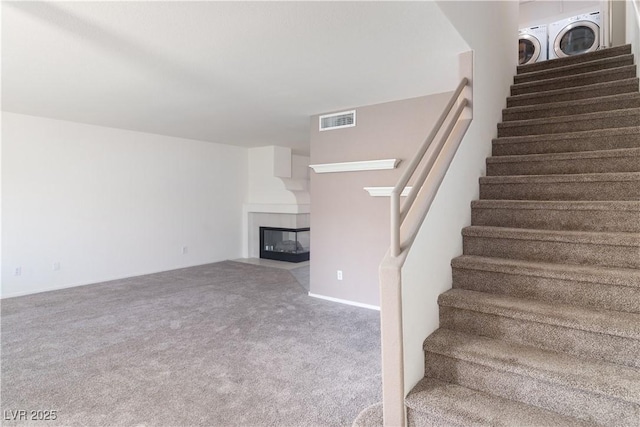2219 Rugged Mesa Dr, Laughlin, NV 89029 - stairs with carpet flooring and a fireplace