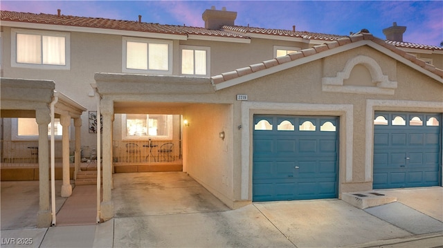 2219 Rugged Mesa Dr, Laughlin, NV 89029 - view of property with concrete driveway, stucco siding, and a chimney
