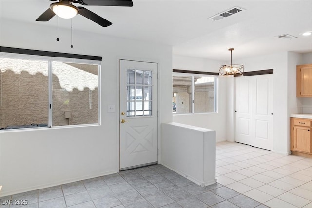 2219 Rugged Mesa Dr, Laughlin, NV 89029 - entryway with light tile patterned flooring, a ceiling fan, and a chandelier
