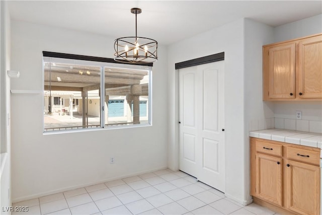 2219 Rugged Mesa Dr, Laughlin, NV 89029 - unfurnished dining area with a chandelier and light tile patterned floors