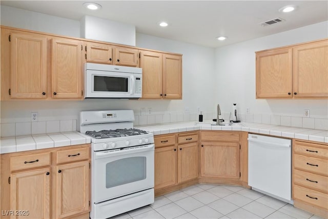 2219 Rugged Mesa Dr, Laughlin, NV 89029 - kitchen with white appliances, light brown cabinets, recessed lighting, and light tile patterned floors