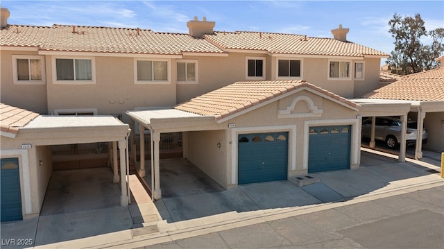 2219 Rugged Mesa Dr, Laughlin, NV 89029 - view of front facade with a tile roof, stucco siding, an attached garage, and a chimney