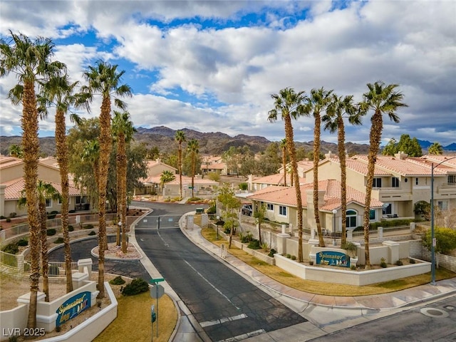 2219 Rugged Mesa Dr, Laughlin, NV 89029 - view of asphalt street with a residential view, curbs, a mountain view, and sidewalks