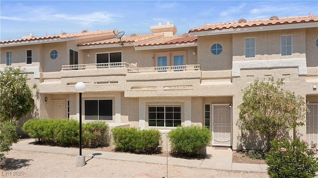 2219 Rugged Mesa Dr, Laughlin, NV 89029 - view of front facade featuring a balcony, stucco siding, and a tiled roof
