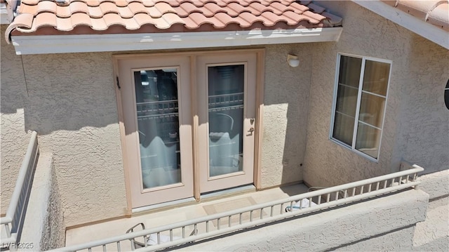 2219 Rugged Mesa Dr, Laughlin, NV 89029 - view of exterior entry with stucco siding and a tile roof