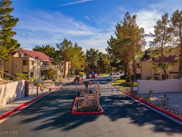 3740 Desert Marina Dr Unit 7, Laughlin, NV 89029 - view of asphalt road with curbs, a gate, a residential view, a gated entry, and sidewalks