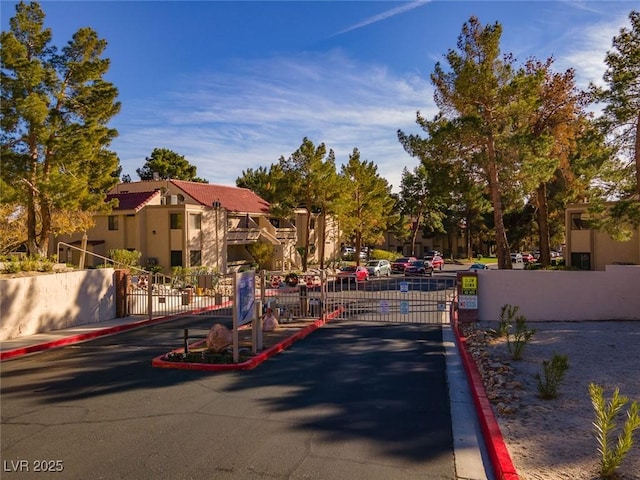 3740 Desert Marina Dr Unit 7, Laughlin, NV 89029 - view of asphalt road with a gate, curbs, a gated entry, and a residential view