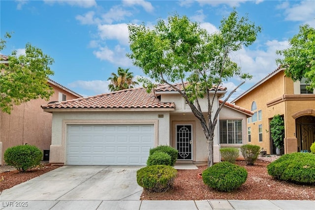 9605 Rainfall Ave, Las Vegas, NV 89147 - mediterranean / spanish house featuring driveway, an attached garage, a tiled roof, and stucco siding