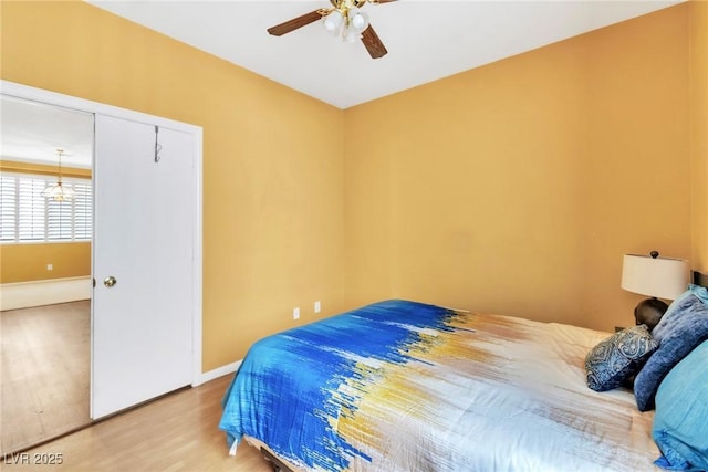 9605 Rainfall Ave, Las Vegas, NV 89147 - bedroom with wood finished floors, ceiling fan, and a chandelier
