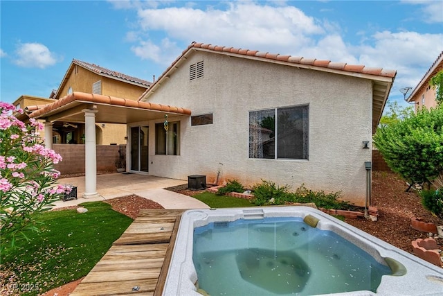 9605 Rainfall Ave, Las Vegas, NV 89147 - back of house with stucco siding, an outdoor hot tub, a patio area, and a tile roof