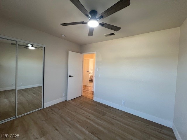 2712 Rialto Rd, Las Vegas, NV 89108 - unfurnished bedroom with wood finished floors, a closet, and a ceiling fan