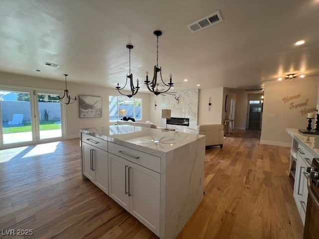 2712 Rialto Rd, Las Vegas, NV 89108 - kitchen featuring a chandelier, plenty of natural light, light wood-style floors, and recessed lighting