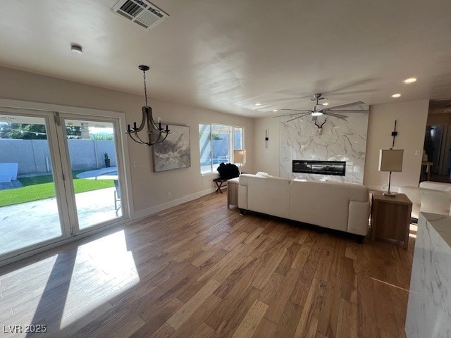 2712 Rialto Rd, Las Vegas, NV 89108 - living room featuring ceiling fan, wood finished floors, a chandelier, recessed lighting, and a fireplace