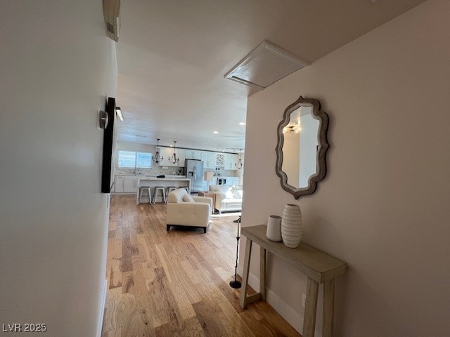2712 Rialto Rd, Las Vegas, NV 89108 - hallway featuring light wood-style flooring, attic access, and recessed lighting