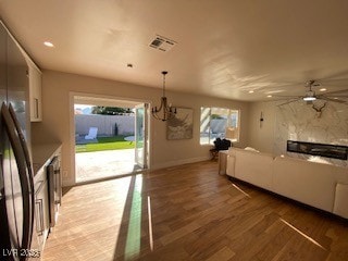 2712 Rialto Rd, Las Vegas, NV 89108 - living room featuring light wood finished floors, a chandelier, a ceiling fan, and recessed lighting