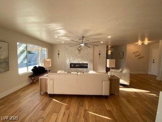2712 Rialto Rd, Las Vegas, NV 89108 - living area with a premium fireplace, ceiling fan, wood finished floors, and recessed lighting