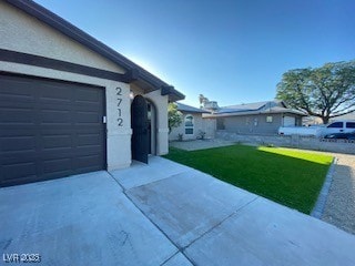 2712 Rialto Rd, Las Vegas, NV 89108 - view of front of property featuring a front lawn, an attached garage, concrete driveway, and stucco siding