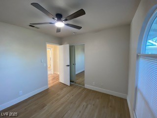 2712 Rialto Rd, Las Vegas, NV 89108 - unfurnished bedroom featuring wood finished floors, a closet, and ceiling fan