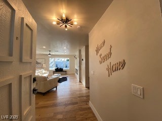 2712 Rialto Rd, Las Vegas, NV 89108 - hallway featuring wood finished floors and a chandelier