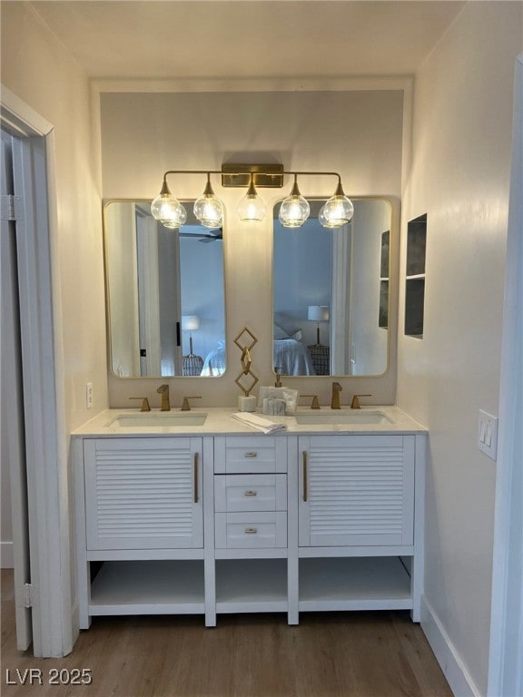 2712 Rialto Rd, Las Vegas, NV 89108 - ensuite bathroom with double vanity and wood finished floors