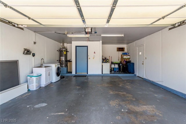 3826 Edmund St, Las Vegas, NV 89103 - garage featuring separate washer and dryer, strapped water heater, and a garage door opener