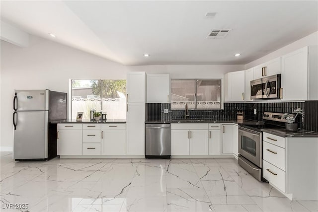 3826 Edmund St, Las Vegas, NV 89103 - kitchen with stainless steel appliances, dark countertops, tasteful backsplash, white cabinets, and recessed lighting