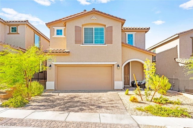 10940 Oregano Ave, Las Vegas, NV 89166 - mediterranean / spanish-style house featuring a tile roof, an attached garage, stucco siding, and decorative driveway