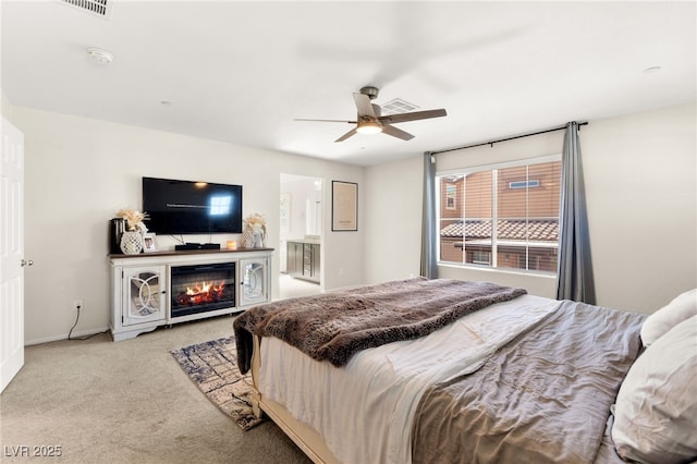 10940 Oregano Ave, Las Vegas, NV 89166 - carpeted bedroom featuring a ceiling fan and a glass covered fireplace