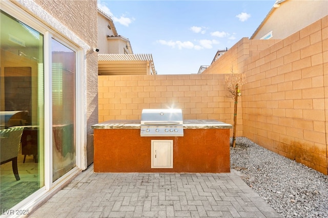 10940 Oregano Ave, Las Vegas, NV 89166 - view of patio / terrace featuring exterior kitchen