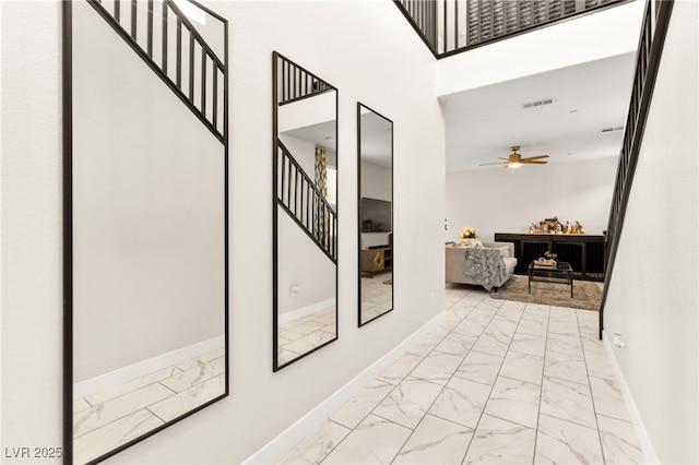 10940 Oregano Ave, Las Vegas, NV 89166 - hallway featuring marble look tile flooring and stairway