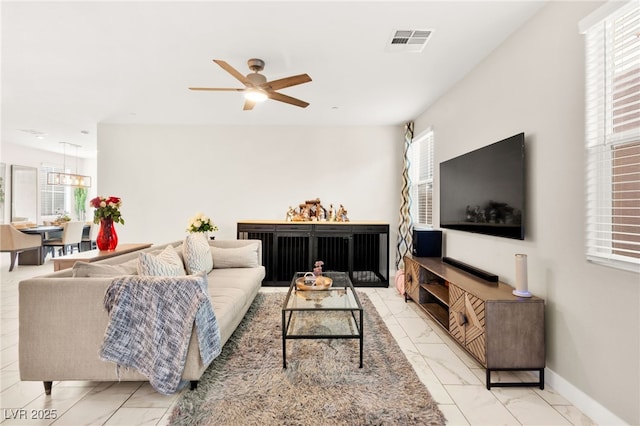 10940 Oregano Ave, Las Vegas, NV 89166 - living room featuring light marble finish flooring and ceiling fan