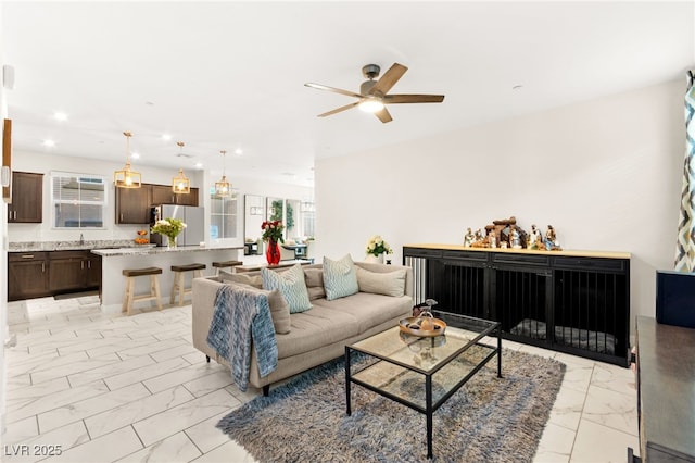 10940 Oregano Ave, Las Vegas, NV 89166 - living area with light marble finish flooring, a ceiling fan, and recessed lighting