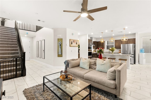 10940 Oregano Ave, Las Vegas, NV 89166 - living room with light marble finish flooring, ceiling fan, stairway, and recessed lighting