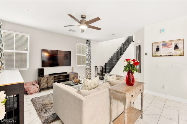 10940 Oregano Ave, Las Vegas, NV 89166 - living room with light marble finish flooring, a ceiling fan, and stairway