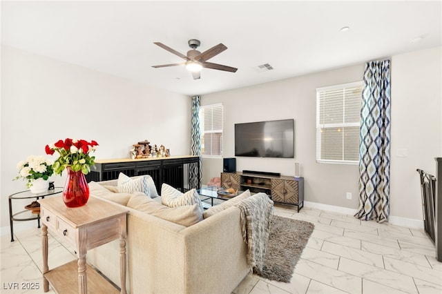10940 Oregano Ave, Las Vegas, NV 89166 - living area featuring light marble finish flooring and a ceiling fan