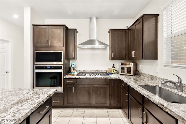 10940 Oregano Ave, Las Vegas, NV 89166 - kitchen with appliances with stainless steel finishes, wall chimney range hood, light marble finish flooring, and light stone counters