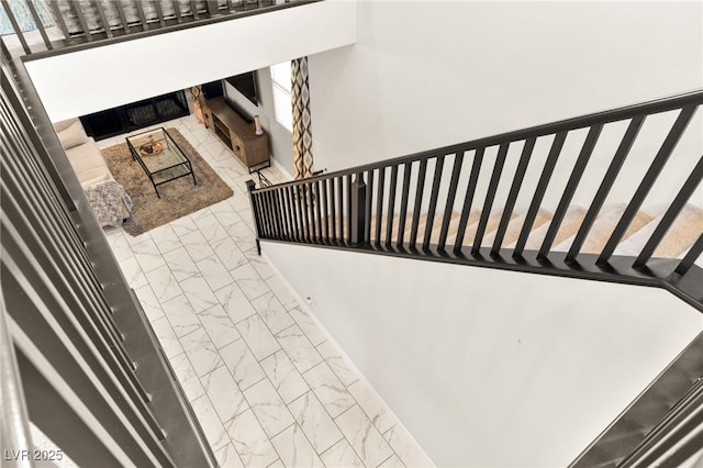 10940 Oregano Ave, Las Vegas, NV 89166 - stairway featuring marble look tiles and a fireplace