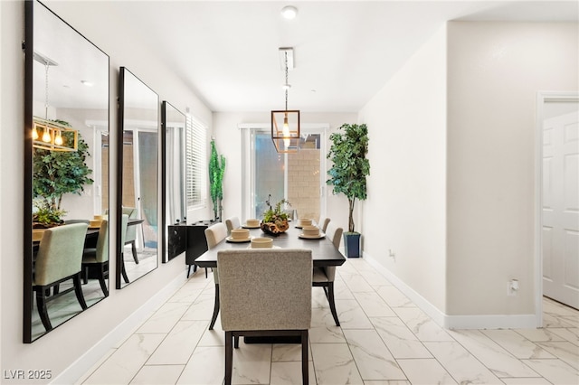 10940 Oregano Ave, Las Vegas, NV 89166 - dining space featuring light marble finish flooring and a chandelier