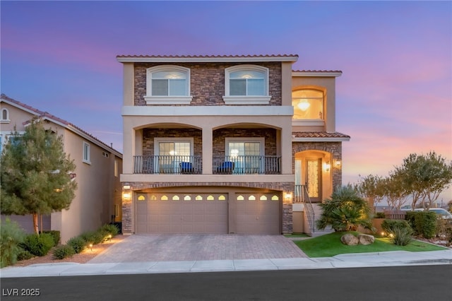 6595 Creekside Cellars Ct, Las Vegas, NV 89139 - view of front of house featuring stone siding, stucco siding, an attached garage, and a tile roof