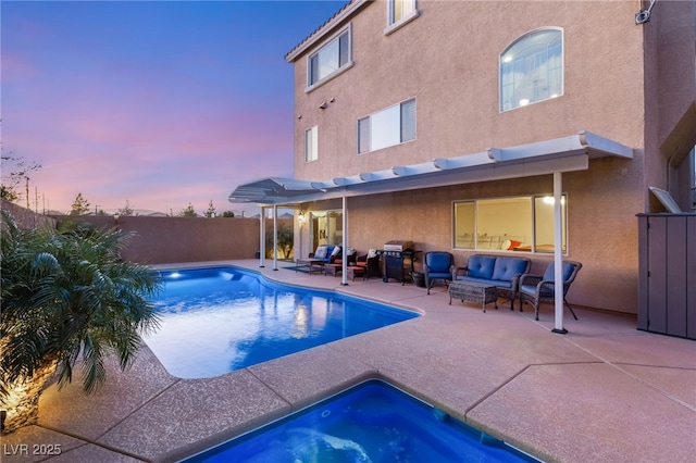 6595 Creekside Cellars Ct, Las Vegas, NV 89139 - pool at dusk featuring outdoor lounge area, a patio area, a fenced backyard, and a grill