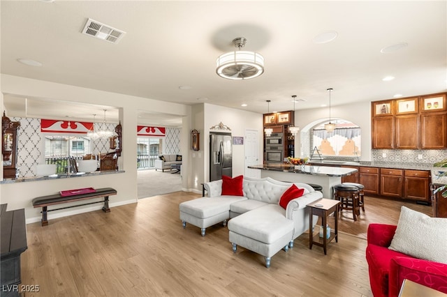6595 Creekside Cellars Ct, Las Vegas, NV 89139 - living room with light wood finished floors, a chandelier, and recessed lighting