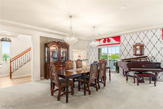 6595 Creekside Cellars Ct, Las Vegas, NV 89139 - dining space featuring a chandelier, light colored carpet, stairway, wallpapered walls, and ornamental molding
