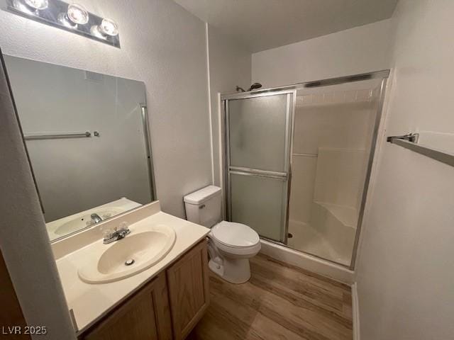 5130 Mandalay Springs Dr Unit 103, Las Vegas, NV 89120 - bathroom featuring wood finished floors, a shower stall, and vanity