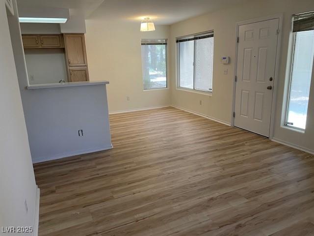 5130 Mandalay Springs Dr Unit 103, Las Vegas, NV 89120 - unfurnished living room with light wood-style flooring and baseboards