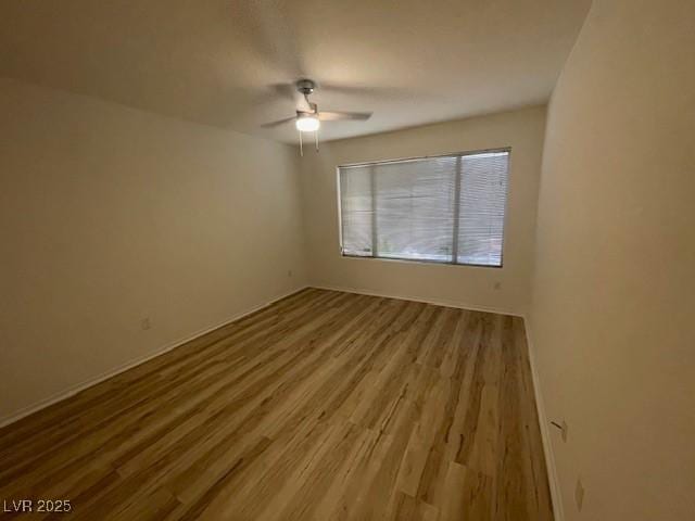 5130 Mandalay Springs Dr Unit 103, Las Vegas, NV 89120 - empty room with ceiling fan and wood finished floors