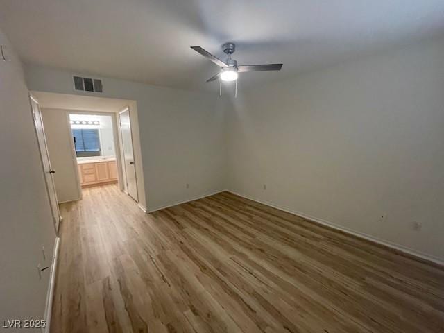 5130 Mandalay Springs Dr Unit 103, Las Vegas, NV 89120 - unfurnished bedroom with wood finished floors and a ceiling fan