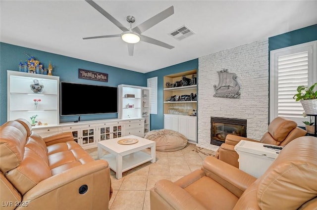 11417 Rock Cove Way, Las Vegas, NV 89141 - tiled living area featuring ceiling fan, built in shelves, and a fireplace