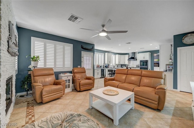 11417 Rock Cove Way, Las Vegas, NV 89141 - living room featuring a ceiling fan, light tile patterned floors, wine cooler, and a stone fireplace