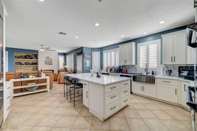 11417 Rock Cove Way, Las Vegas, NV 89141 - kitchen with healthy amount of natural light, light tile patterned floors, a center island, and recessed lighting